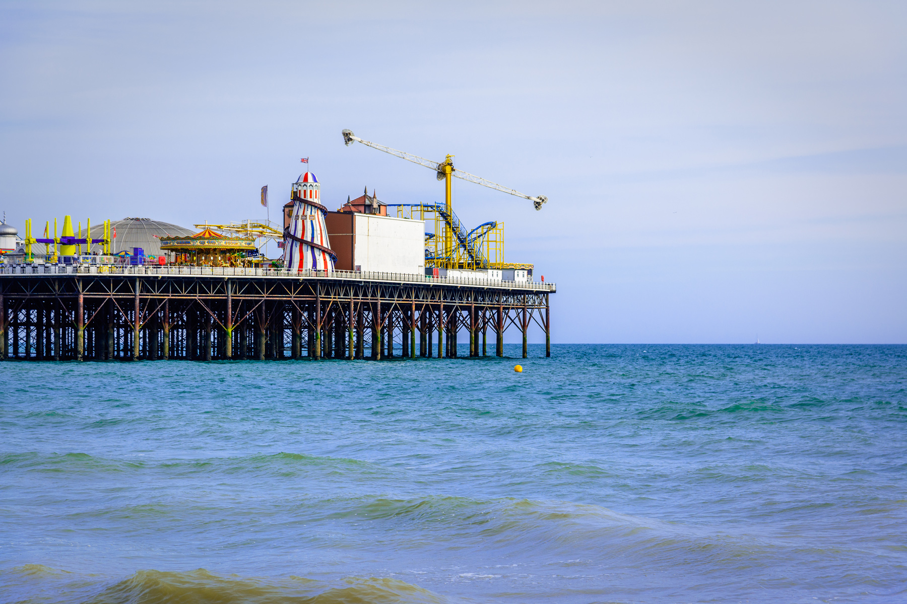 An image of Brighton Pier amusements and the surrounding sea.
